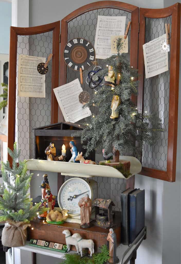 Vintage baby scale decorated with nativity creche.