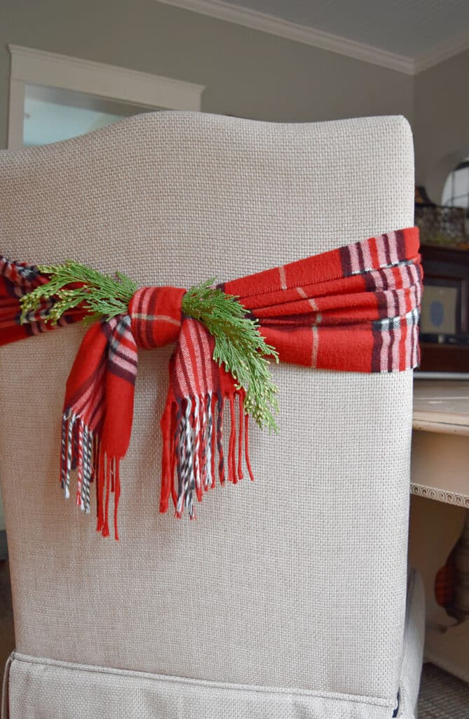 Plaid scarf decorating an upholstered dining chair