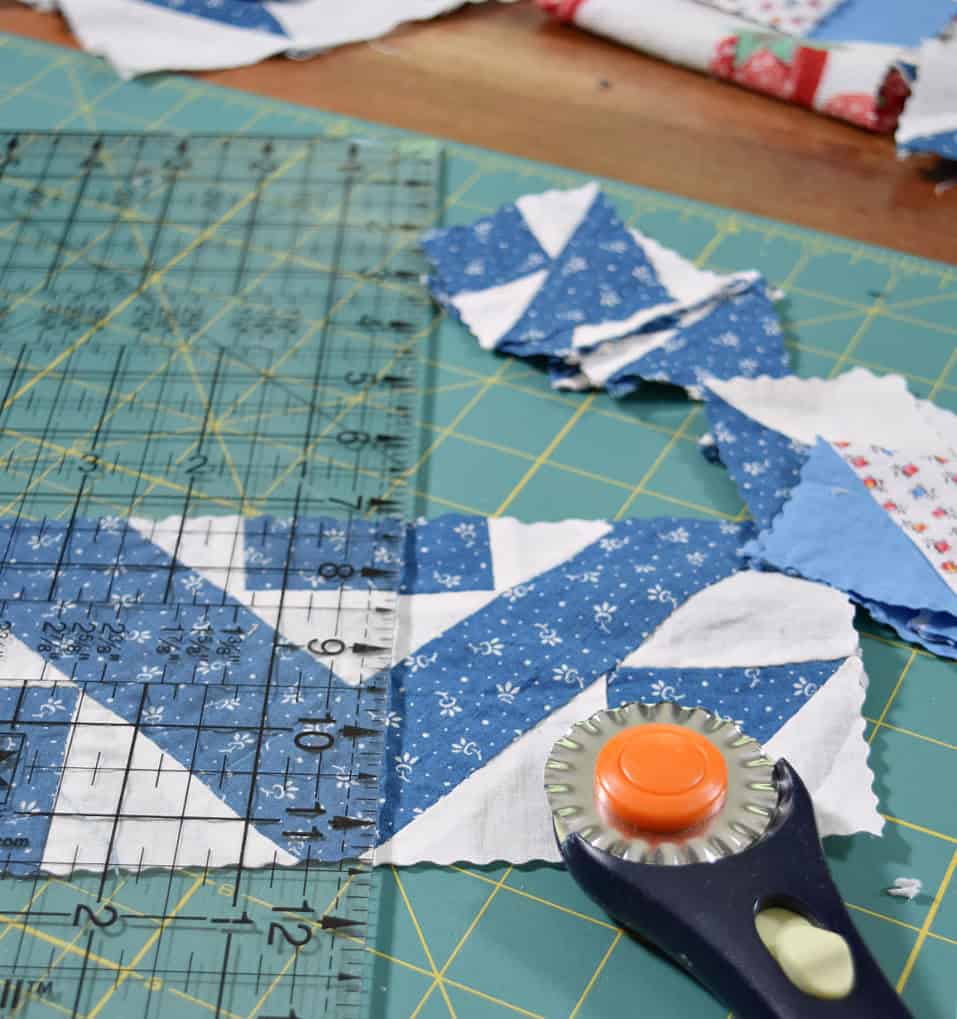Cutting quilt scraps with rotary.