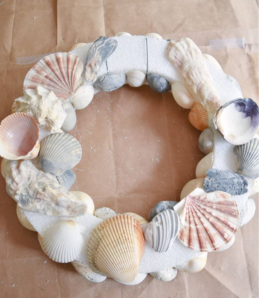 Gluing seashells to styro wreath.