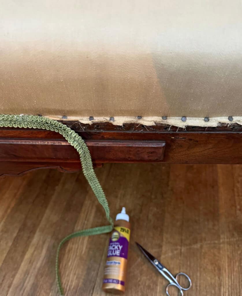 Glueing gimp on antique furniture.