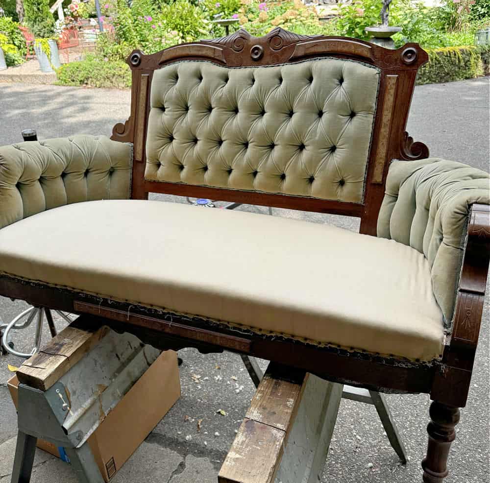 Deconstructing an antique velvet tufted settee.