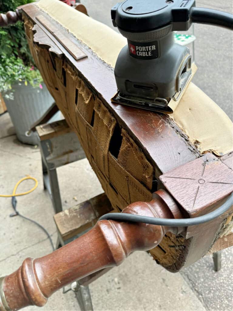 Sanding frame of antique settee.