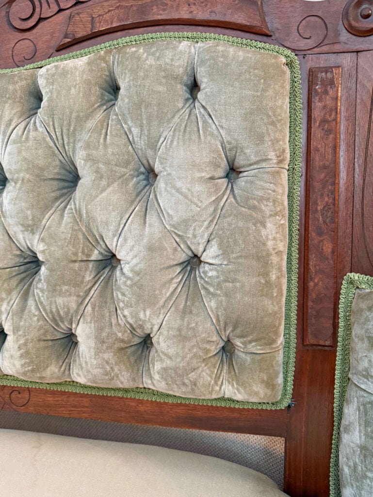 Green velvet button tufting on settee.