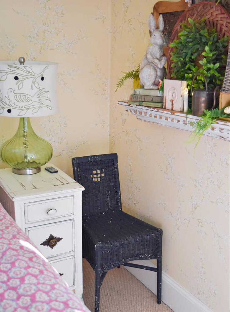 Vintage black wicker chair in bedroom.