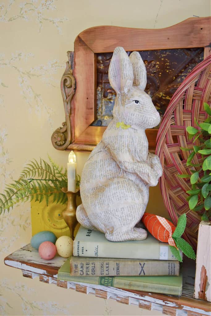 Standing bunny figure on Spring decorated shelf.