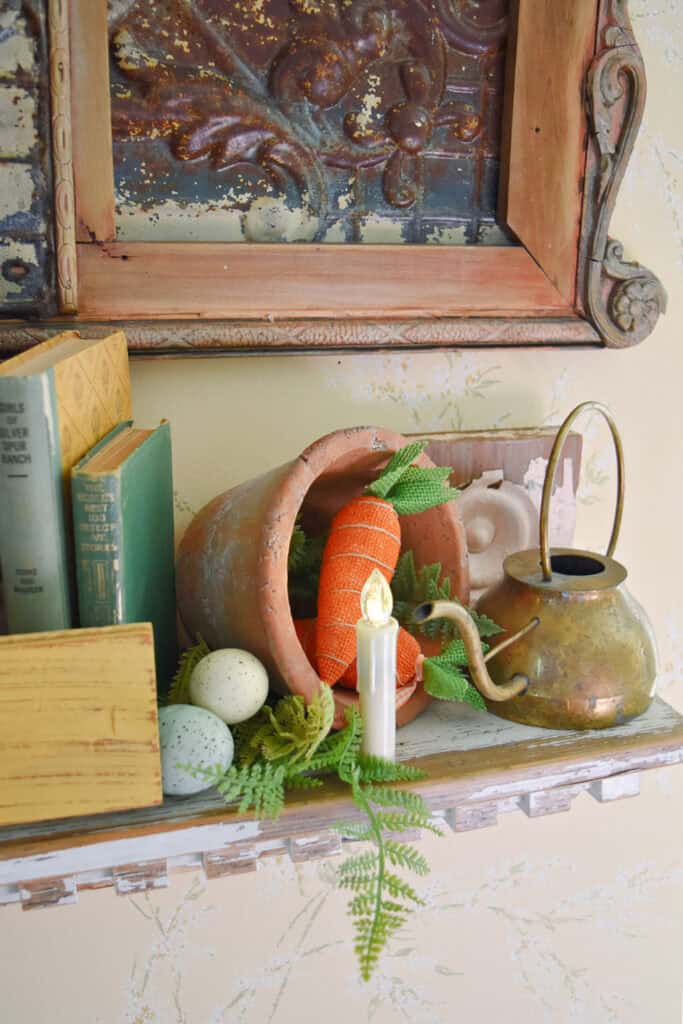 Faceted battery candle on Spring decorated shelf.