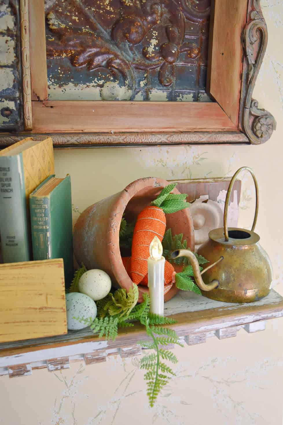 Faceted battery candle on Spring decorated shelf.
