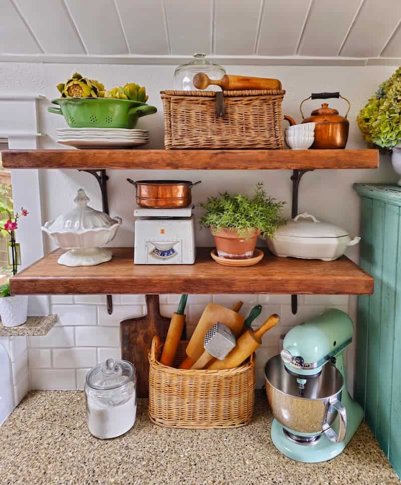 Open kitchen shelves with vintage decor.