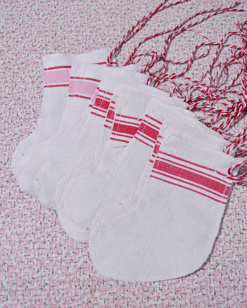 Handcrafted red grain sack mini Christmas stockings.