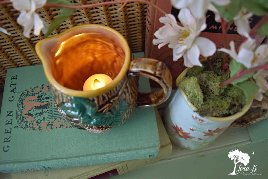 Candle in small pitcher.
