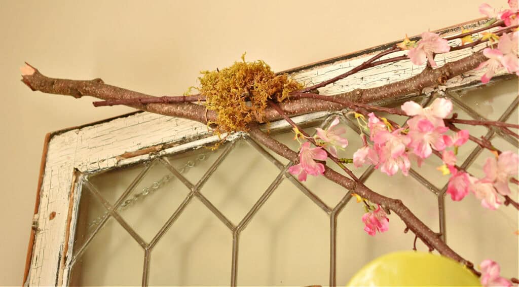Faux apple blossoms on branch as Spring decor.