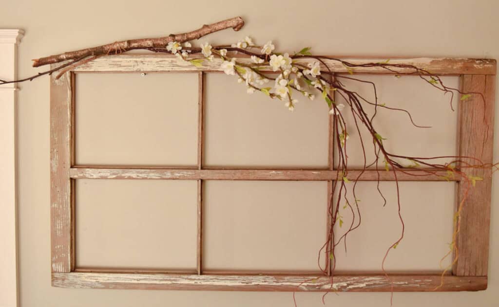 Branches attached to old window frame as Spring decor.
