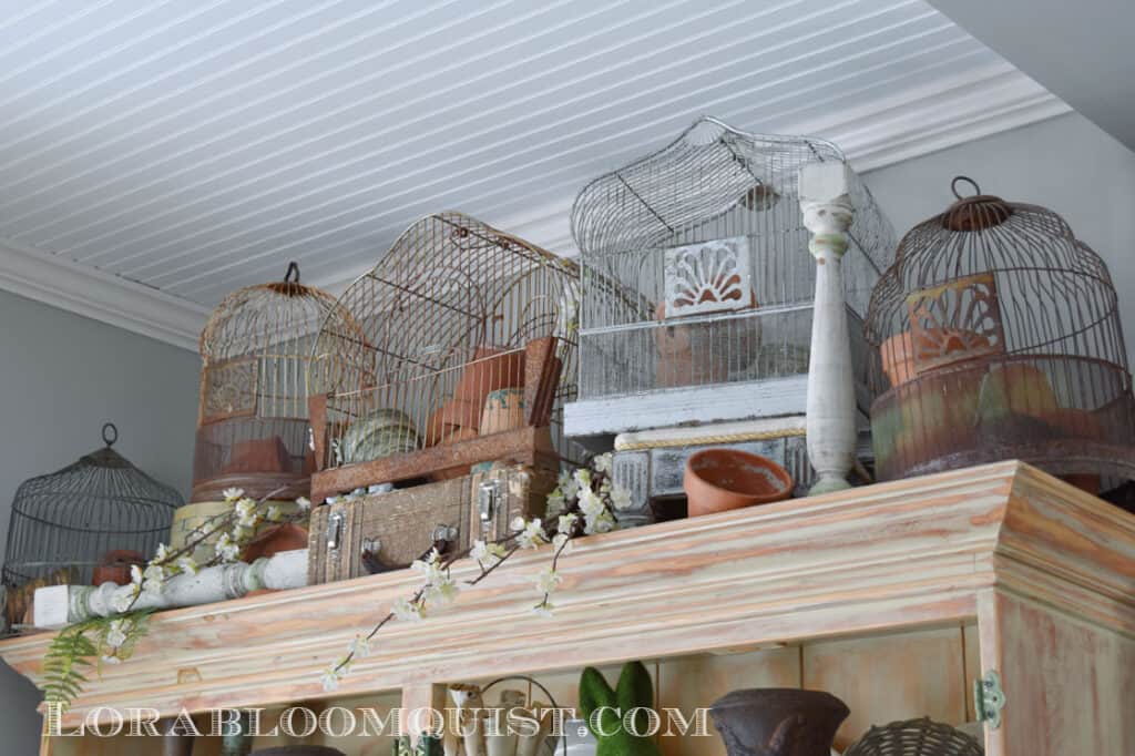 Vintage birdcages on top of a Spring decorated hutch