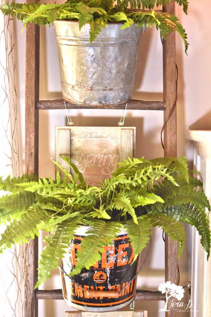 Buckets hanging on a ladder for decor