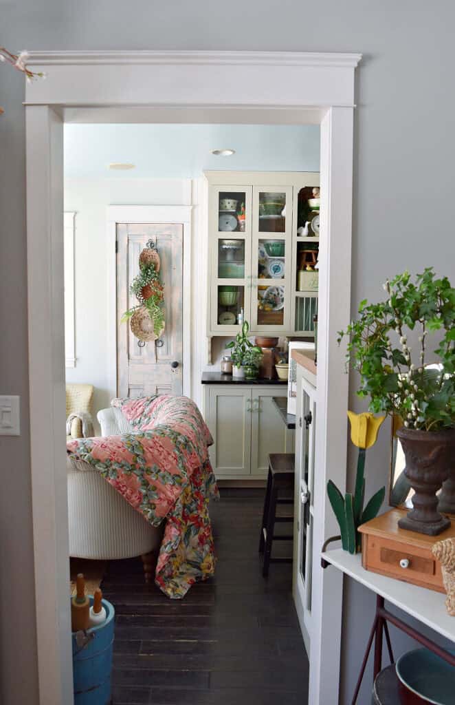 Doorway to Farmhouse kitchen, decorated for Spring with vintage finds.