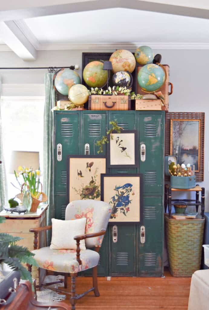 Green lockers decorated with vintage globe collection and Audubon bird prints.