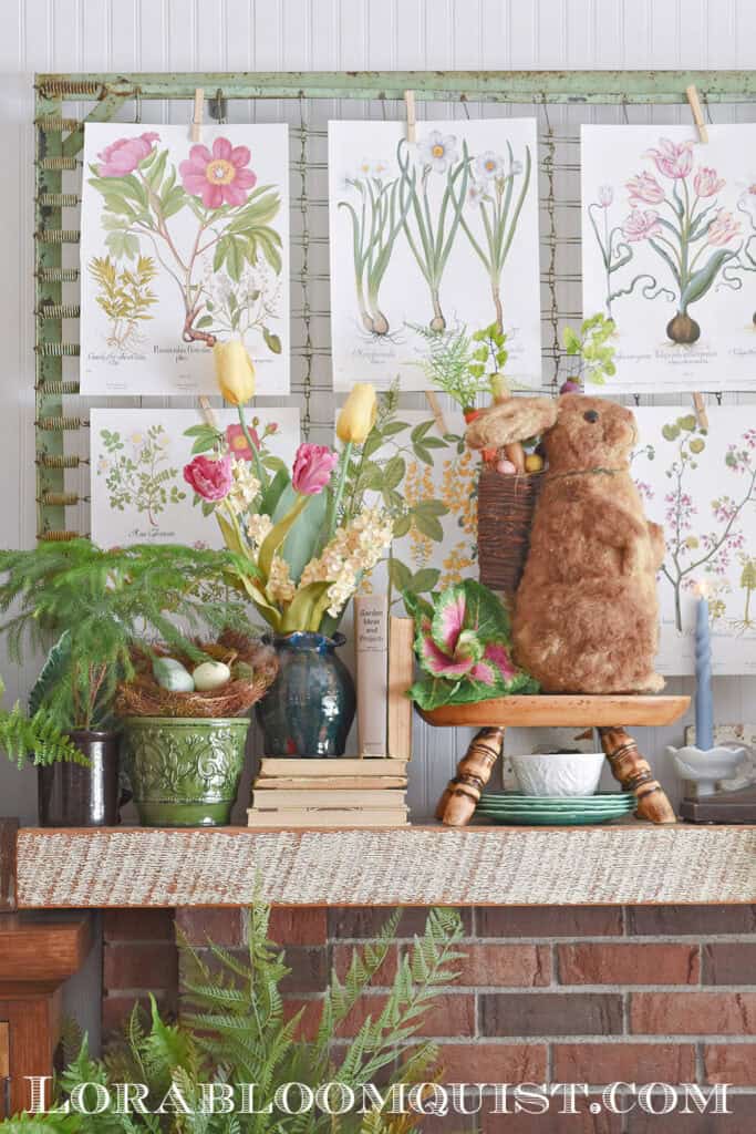 Spring mantel display with floral botanical art, faux flowers, bunny and nest.