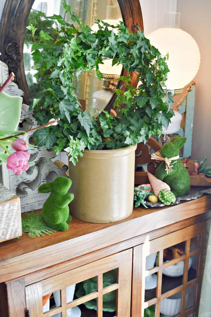 Ivy topiary and moss bunnies as Spring shelf decor.