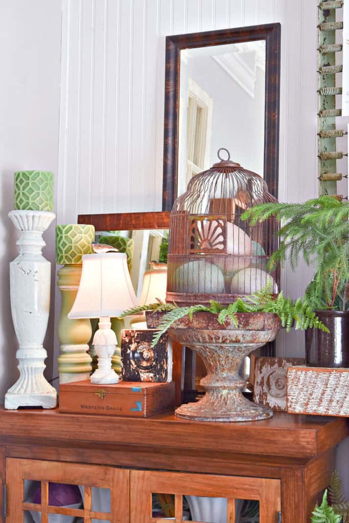 Vintage birdcage with eggs as Spring shelf decor.