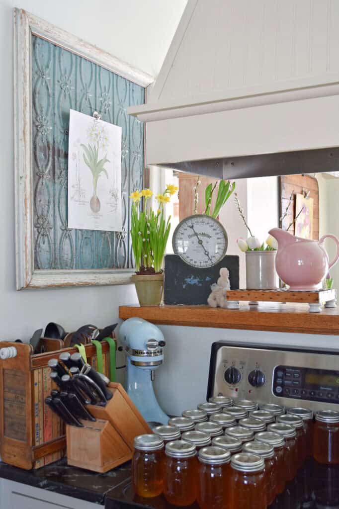 Spring decorated kitchen vignette with maple syrup pints.
