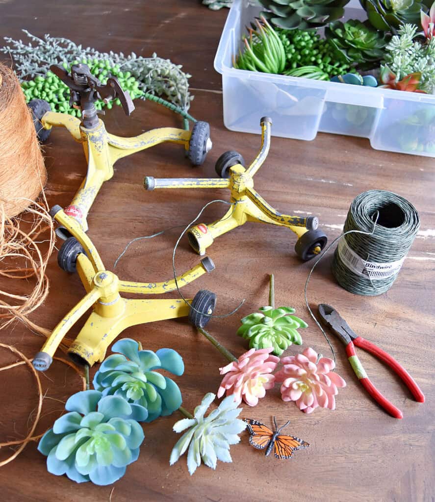 Old yellow sprinklers with faux succulents.