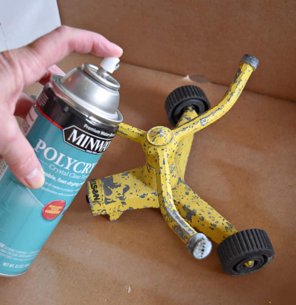 Spraying old sprinkler with poly.