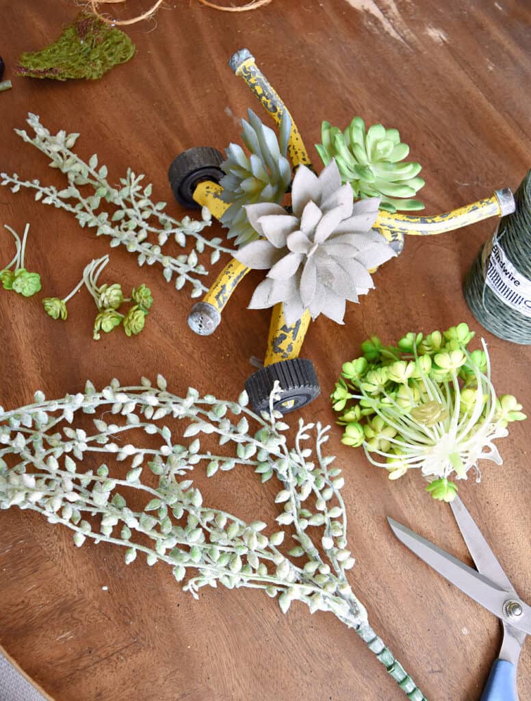 Old yellow sprinkler with succulents.