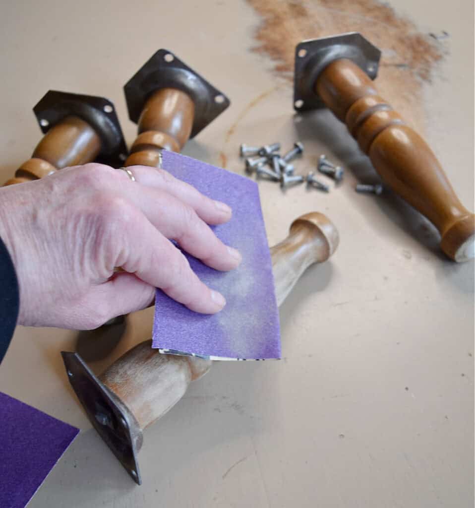 Sanding legs of old footstools.