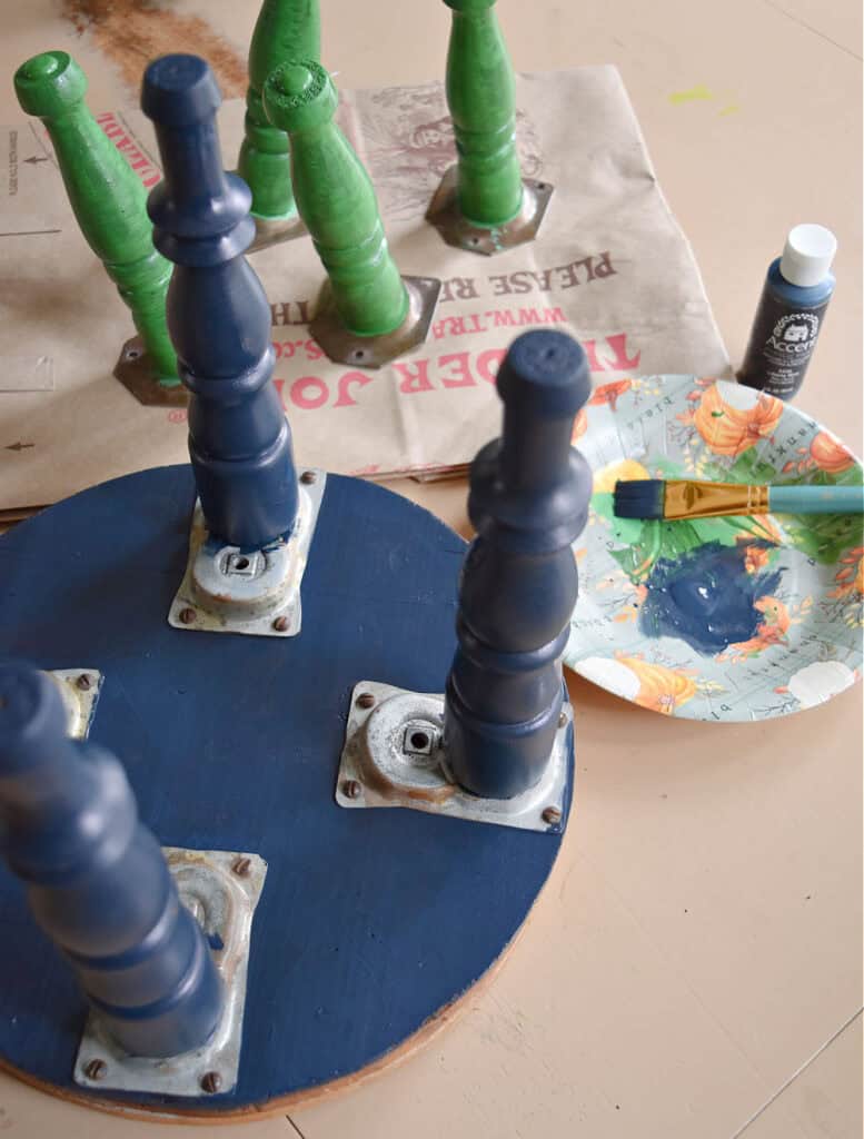 Painting legs of old footstools.