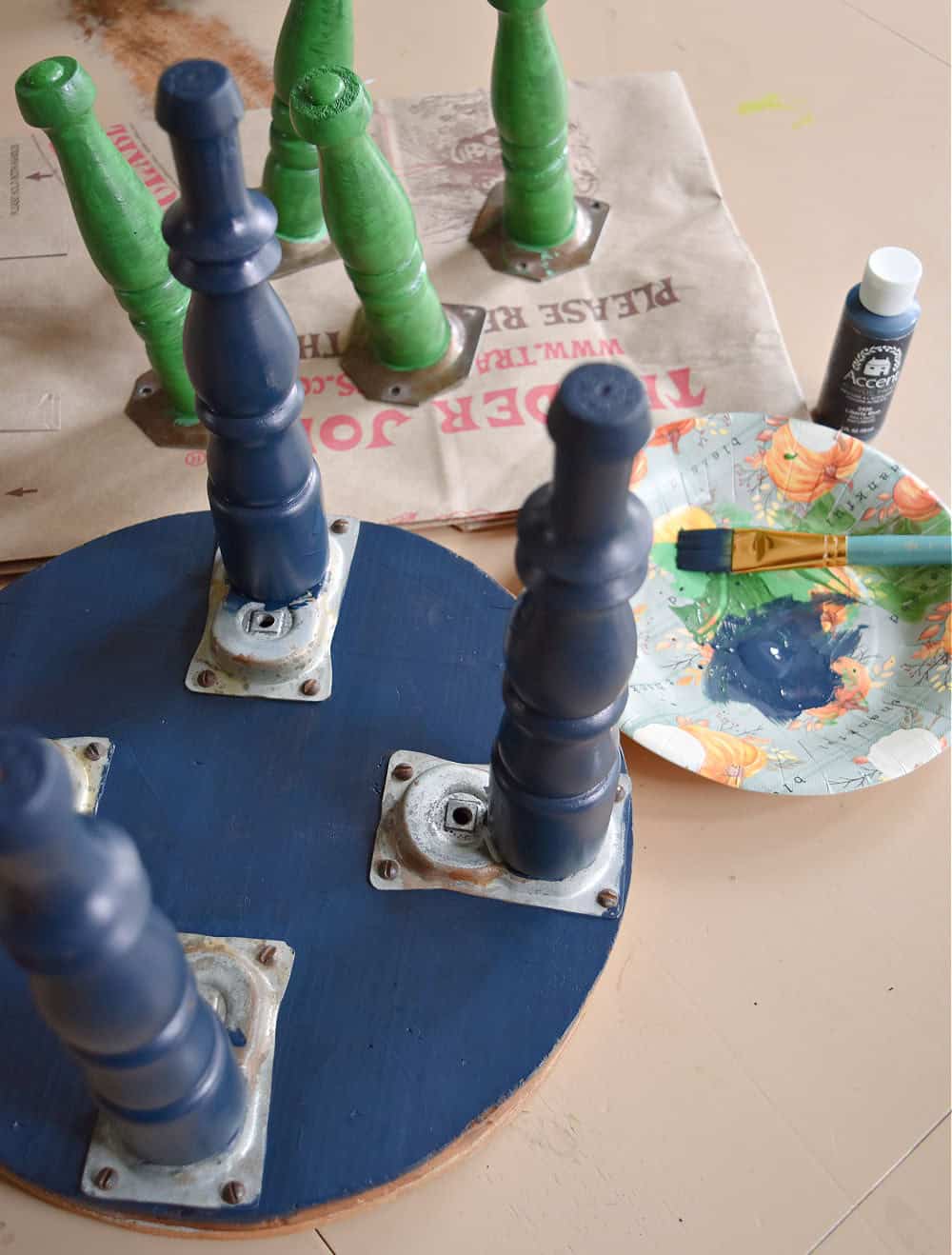 Painting legs of old footstools.