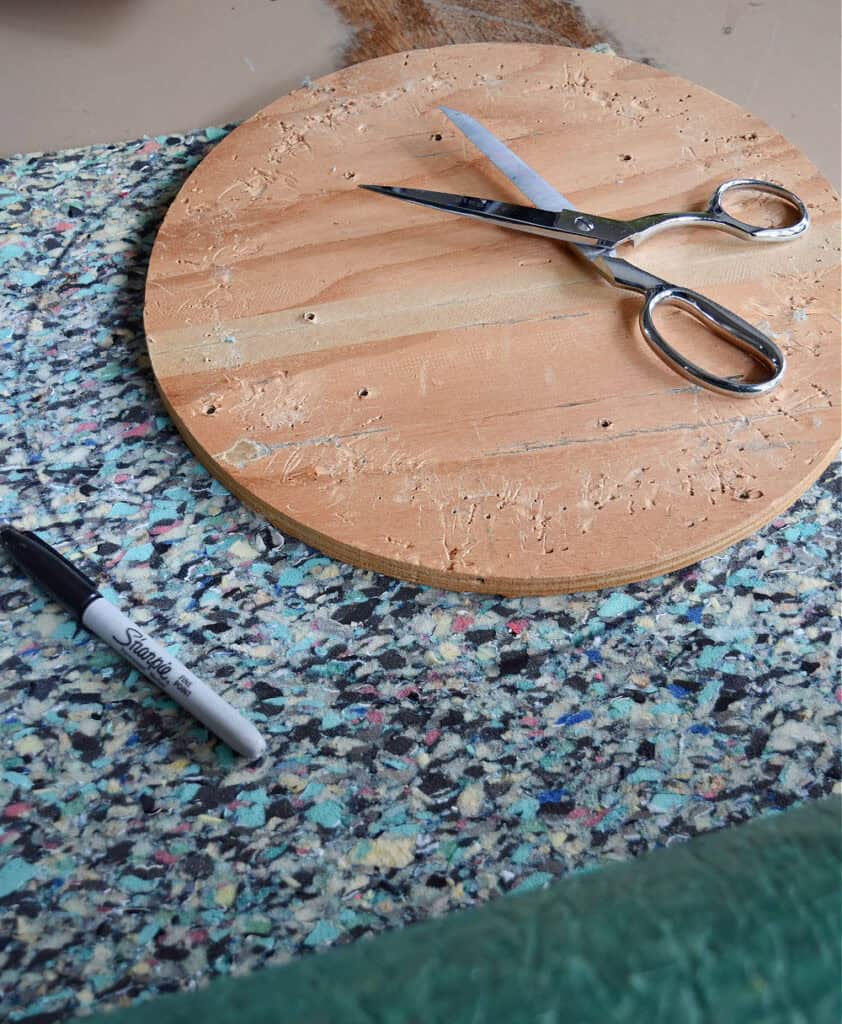 Cutting carpet pad for stool makeover.
