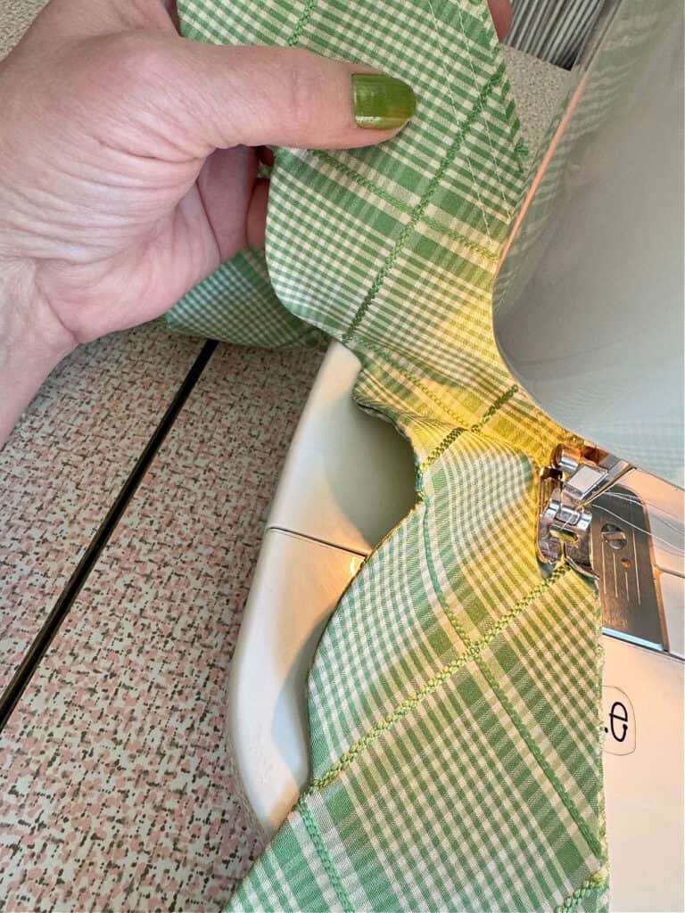 Sewing scalloped fabric trim.