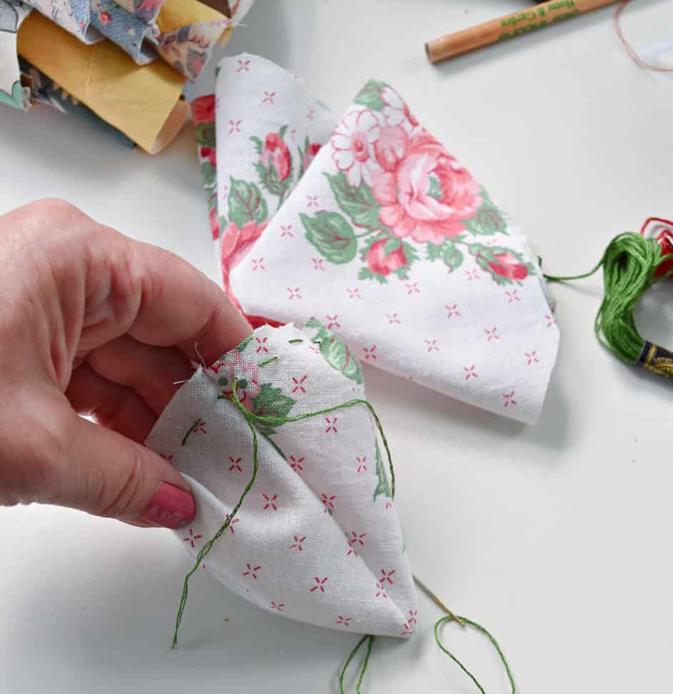 Baste stitching around top of fabric strawberry.
