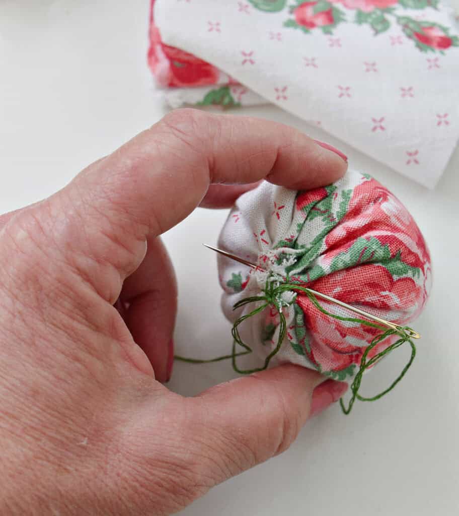 Sewing fabric strawberries.