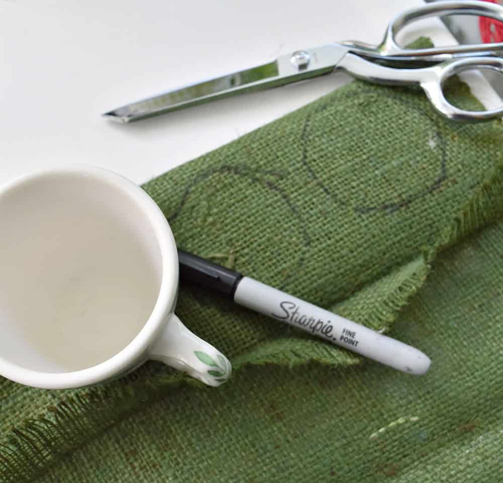 Cutting circles of burlap for fabric strawberries.