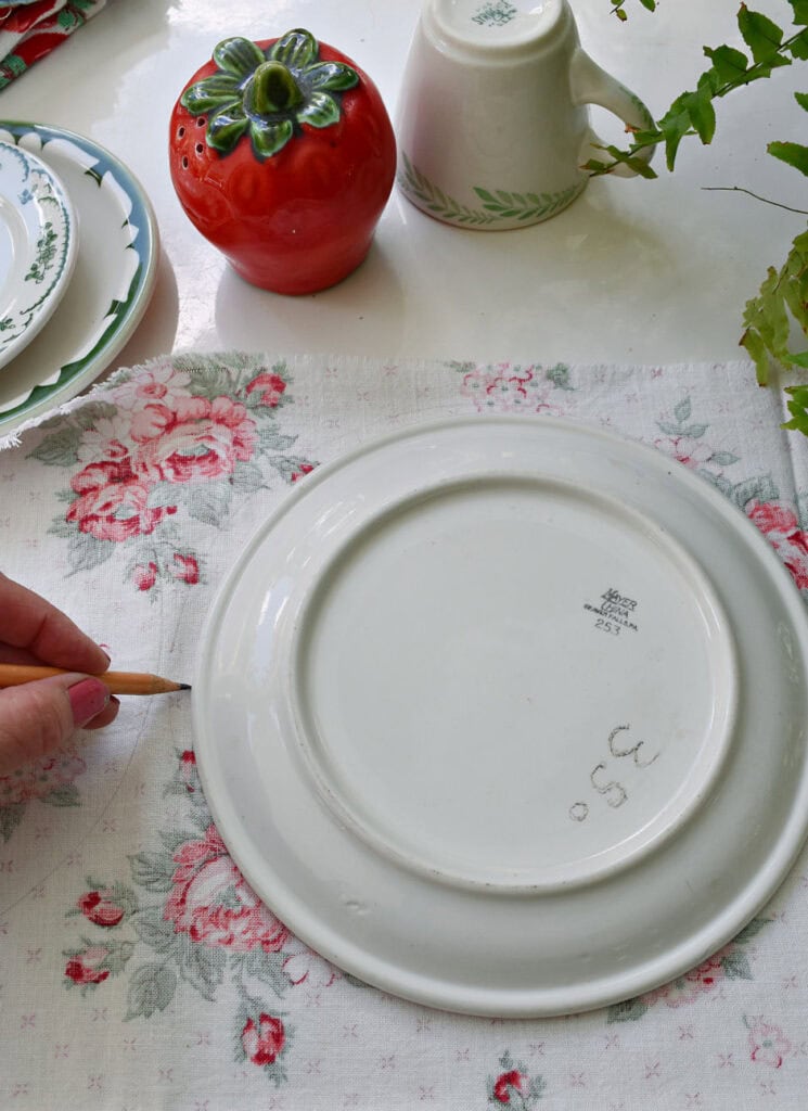 Drawing around plate to craft upcycled fabric strawberries.