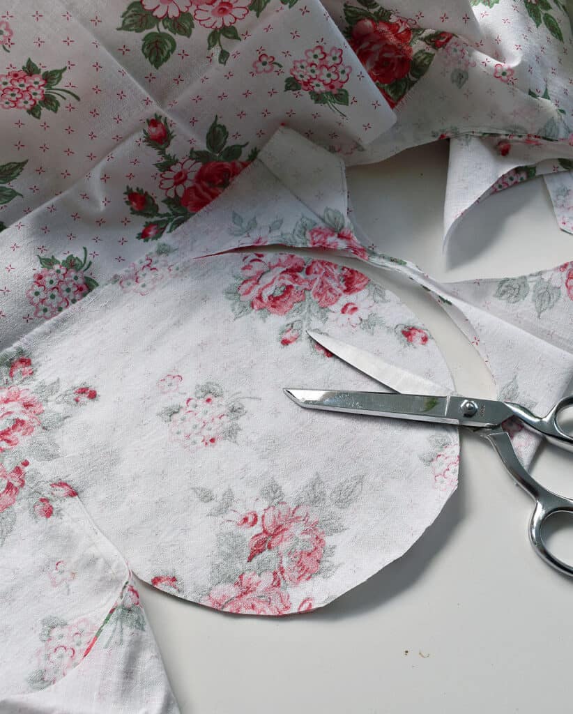 Cutting vintage fabric circles for upcycled strawberries.