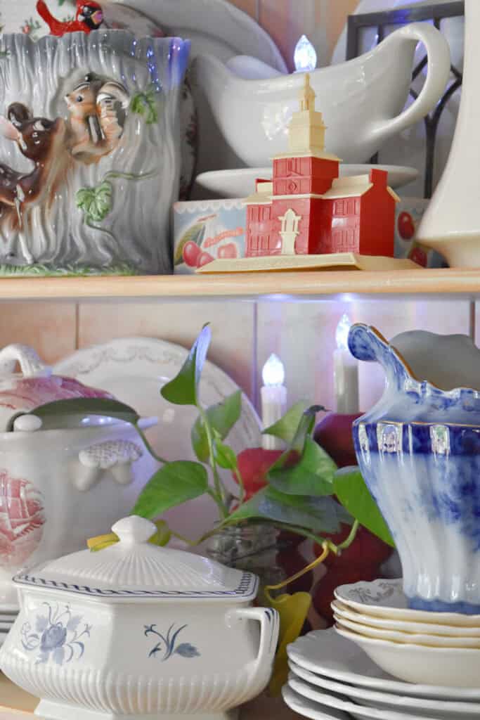 Patriotic decorated summer hutch decor with vintage red, white and blue dishes.