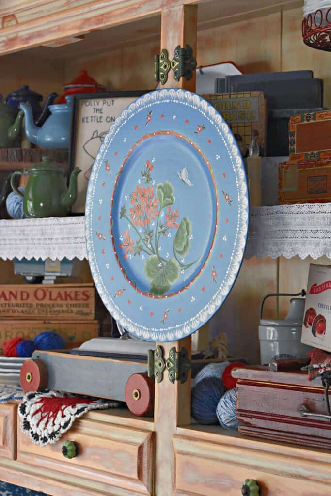 Hand painted blue wooden plate as summer hutch display.
