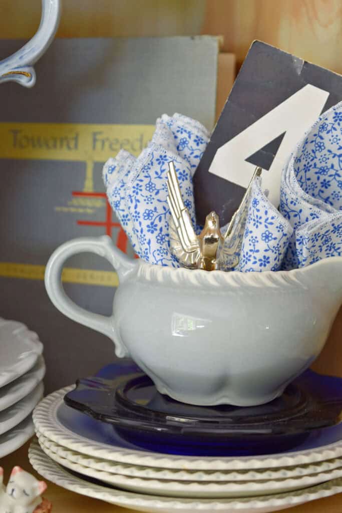 Vintage dishes stack with paper number 4.
