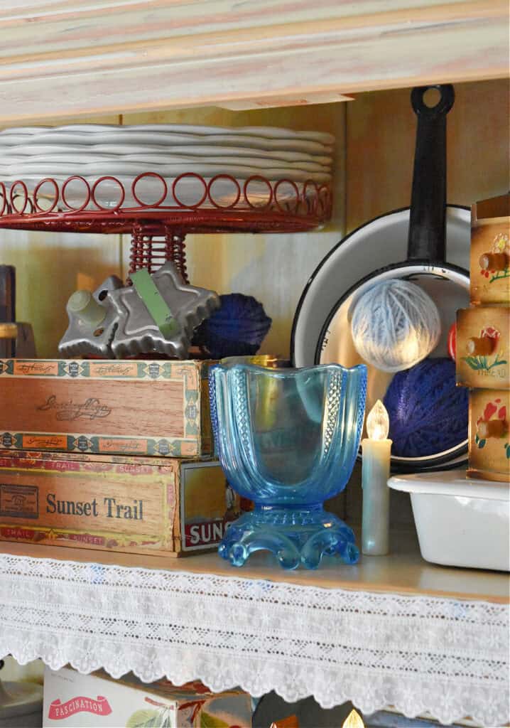 Aqua blue glass vase in summer hutch display.