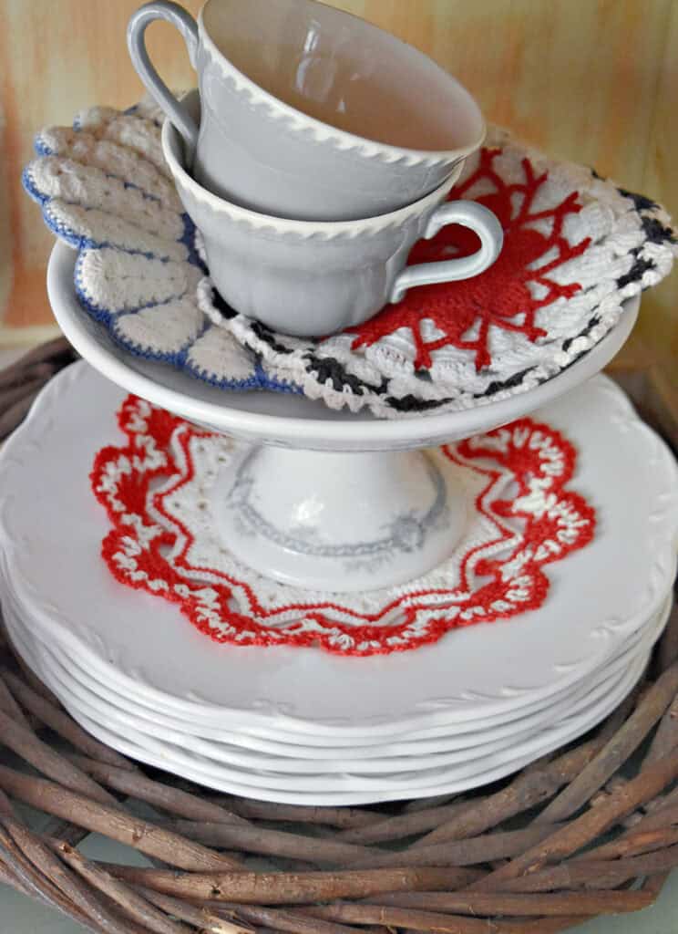 Red, white and blue vintage crocheted hot pads as Patriotic hutch decor.