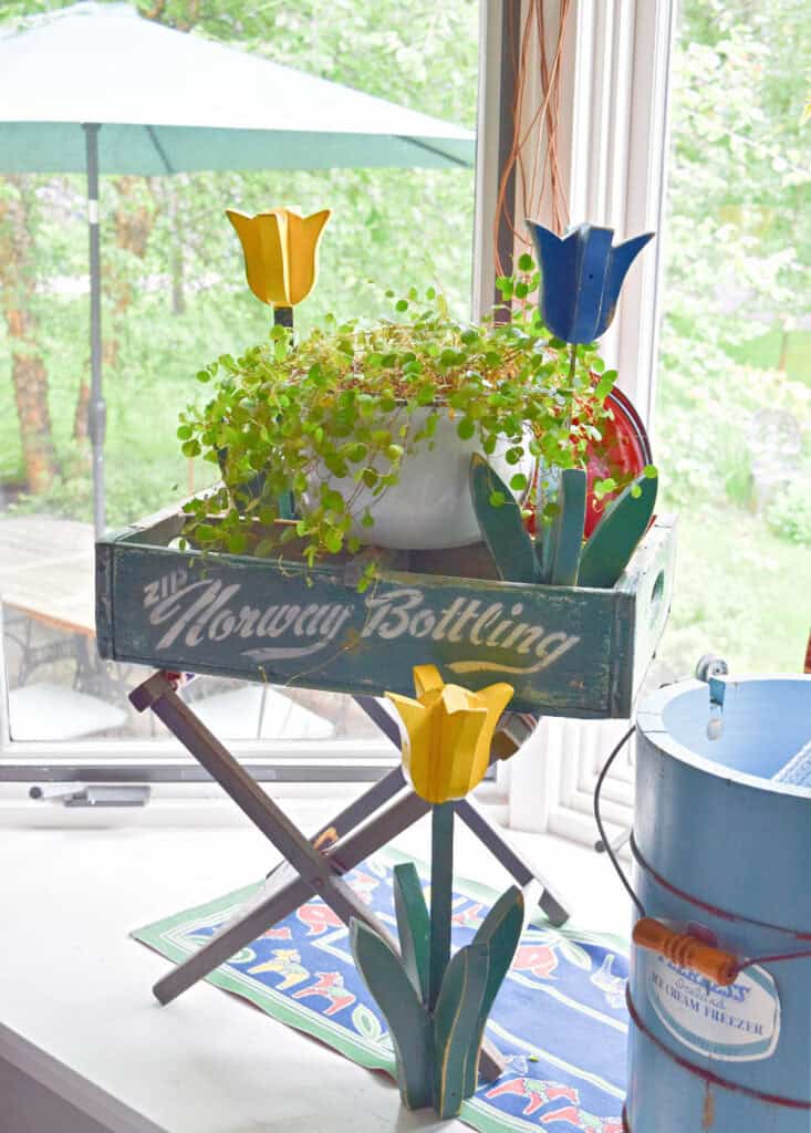 Wooden tulips and old pop bottle crate as summer vignette.