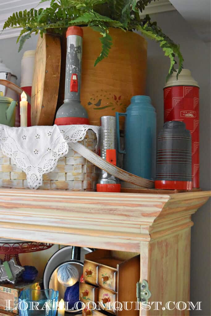 Vintage thermos collection as summer hutch display.