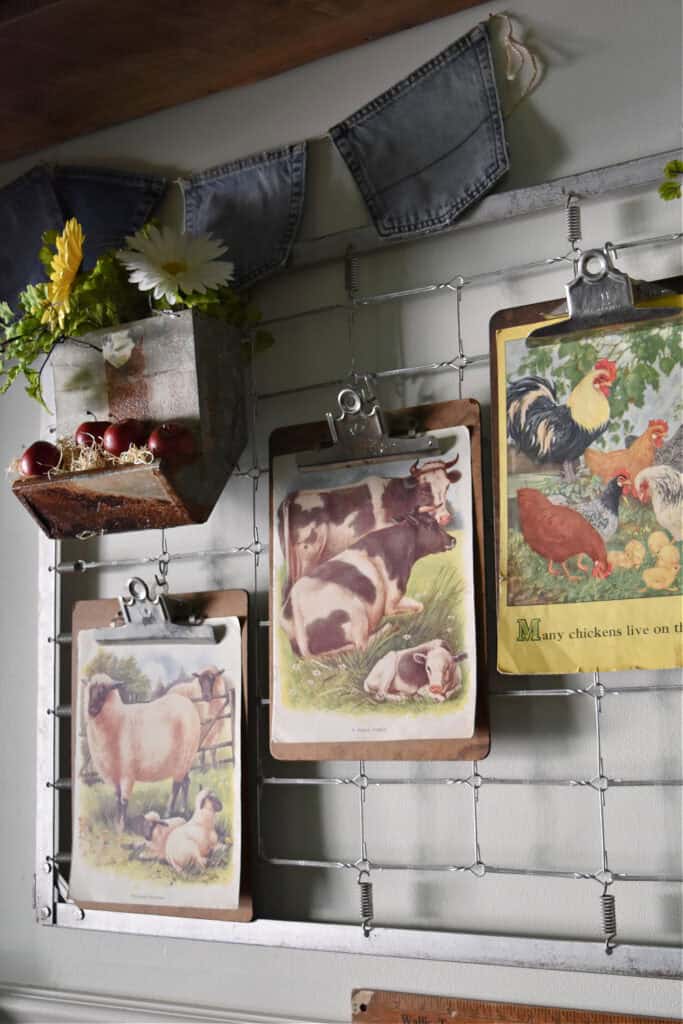 Vintage farmyard children's book illustrations on clipboards as art.