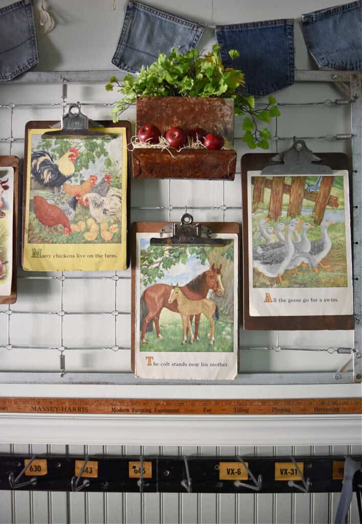Vintage farmyard children's book illustrations on clipboards as art.