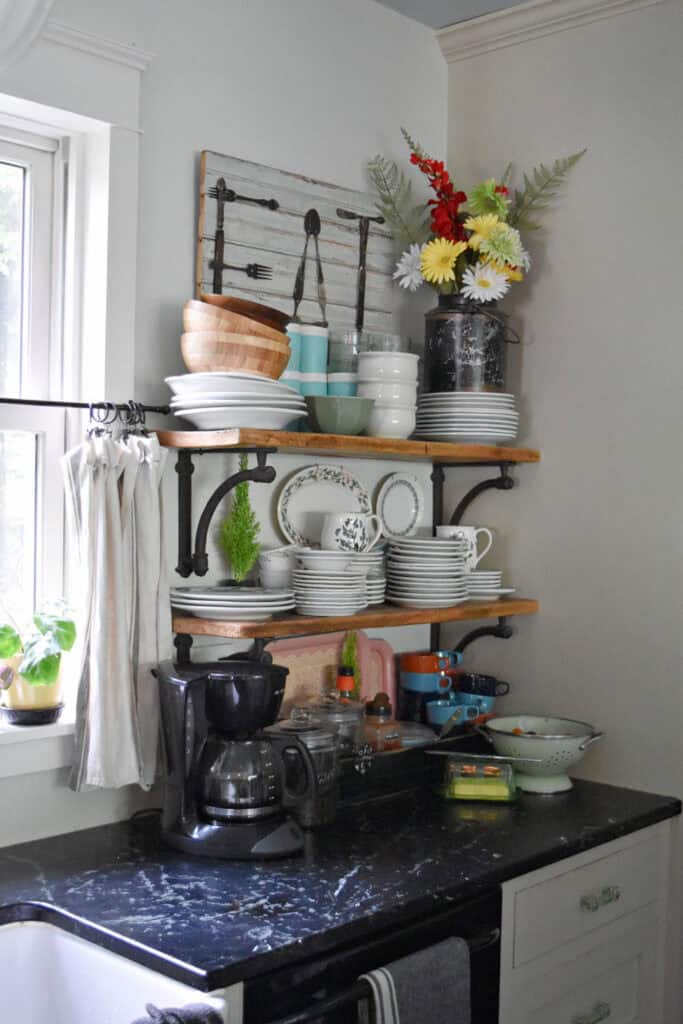 Open kitchen shelves with vintage dishes.
