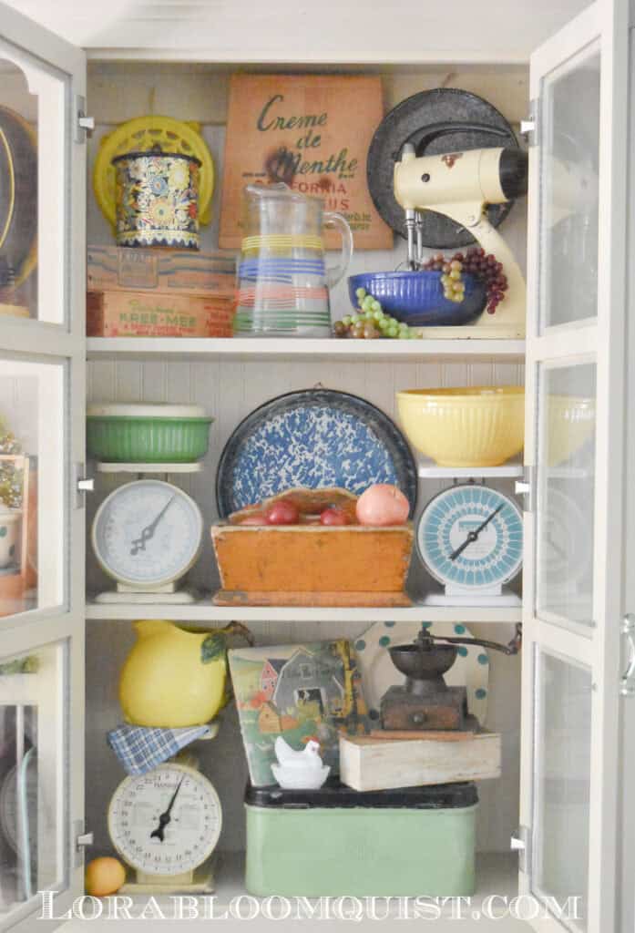 Summer themed kitchen shelf display with vintage finds.