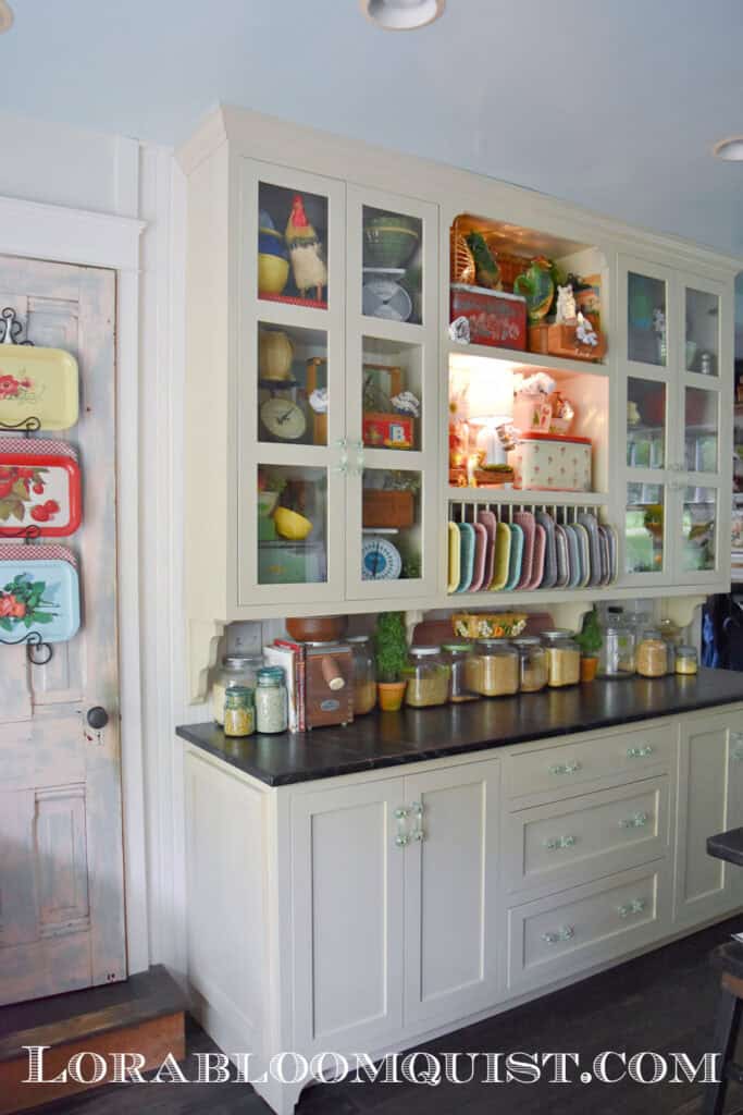 Kitchen cupboards filled with vintage finds and nostalgic decor.
